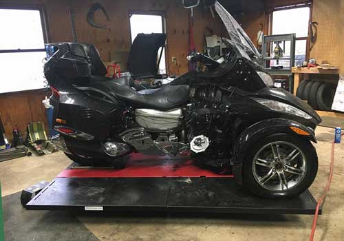 Can Am Spyder RT atop the Elevator 1800 Motorcycle ATV Lift Table getting service.